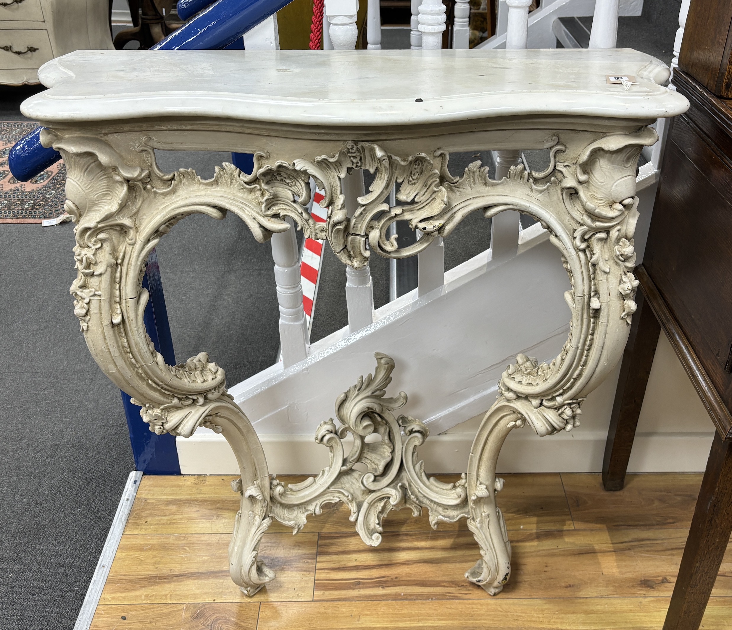 A Victorian carved wood and composition marble top serpentine console table, width 88cm, depth 45cm, height 90cm